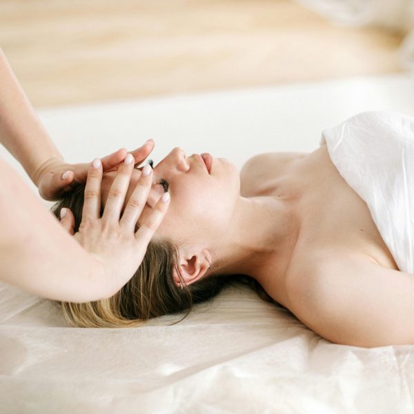 Woman receiving a soothing facial massage at a luxurious spa, enhancing relaxation and wellness.
